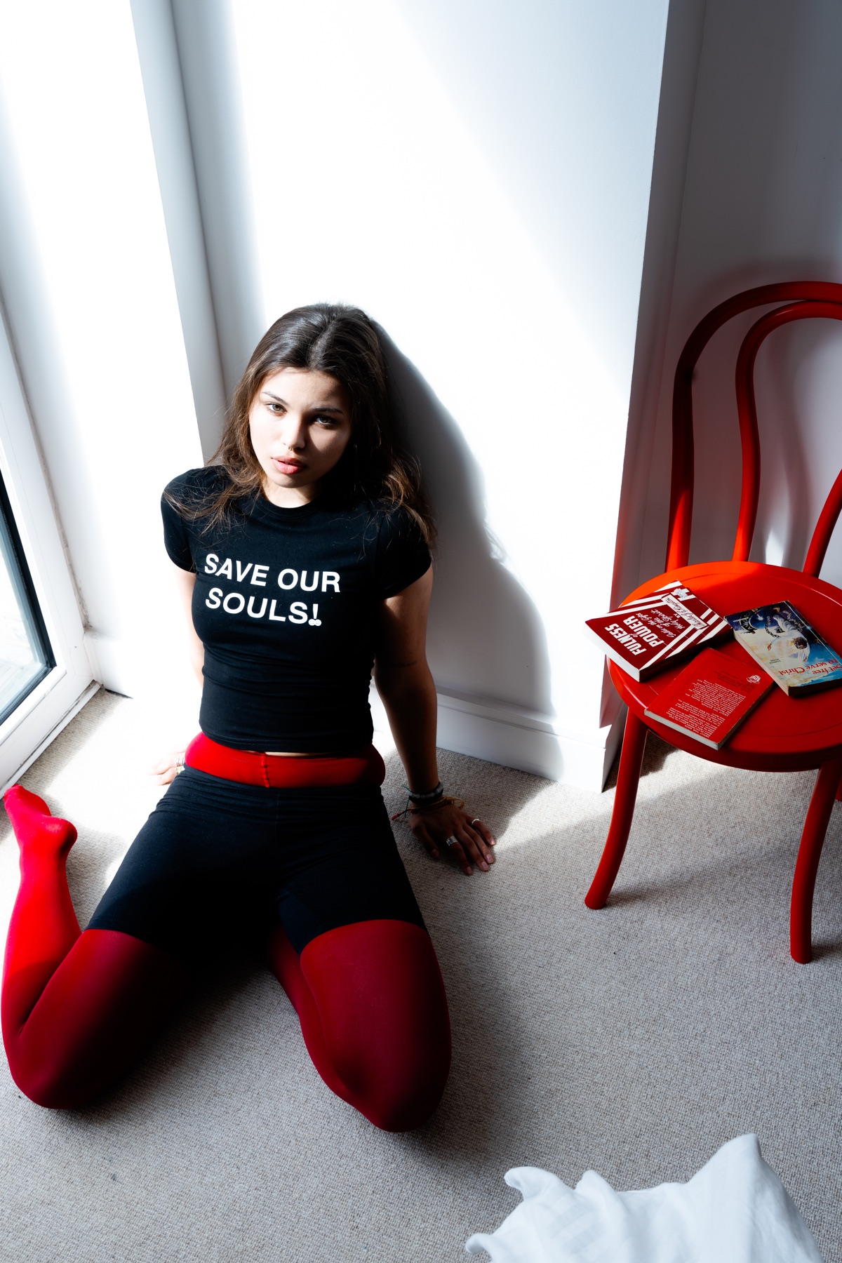 Save Our Souls campaign portrait beside a red chair