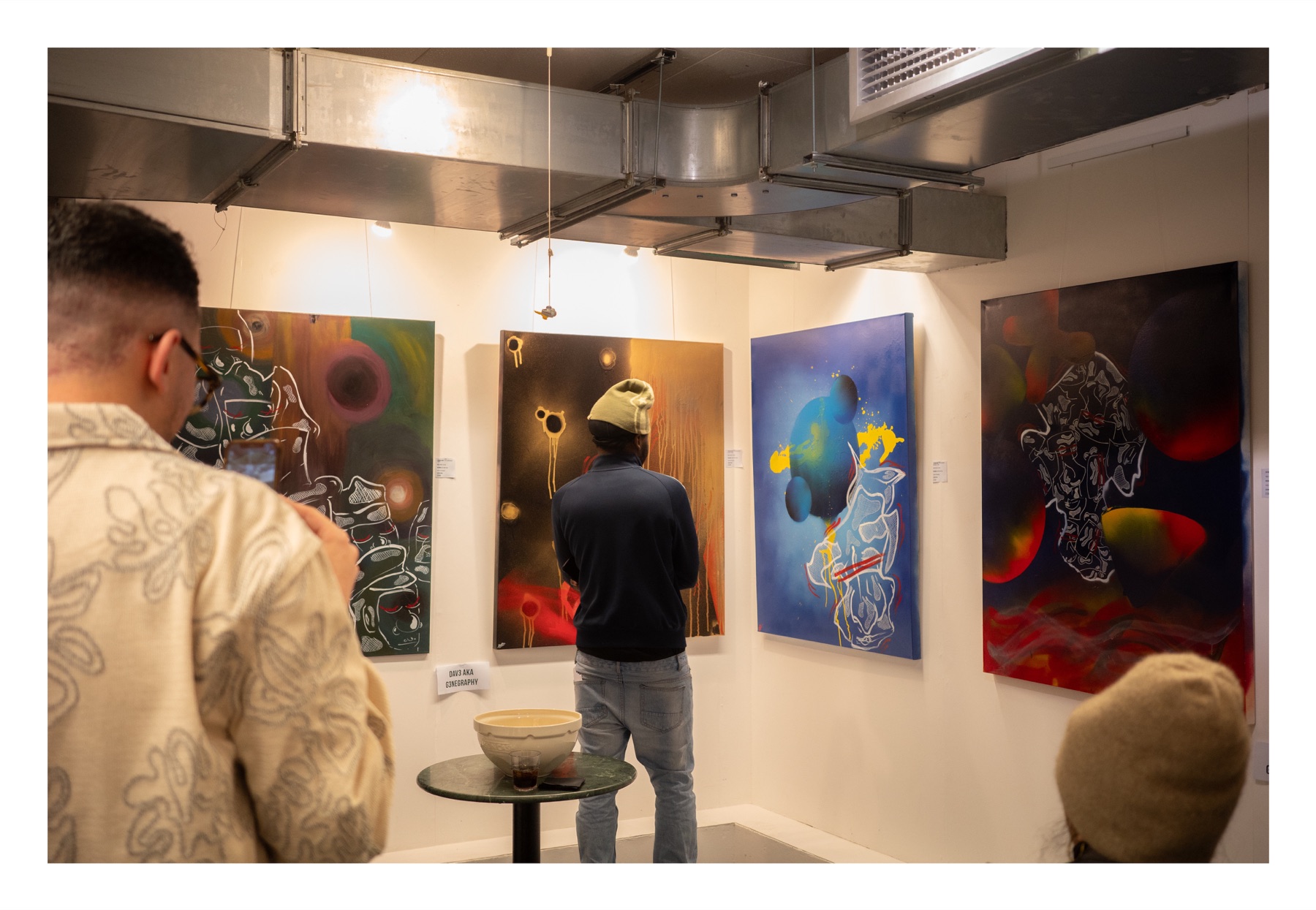 Visitors viewing paintings at a private Soho art auction